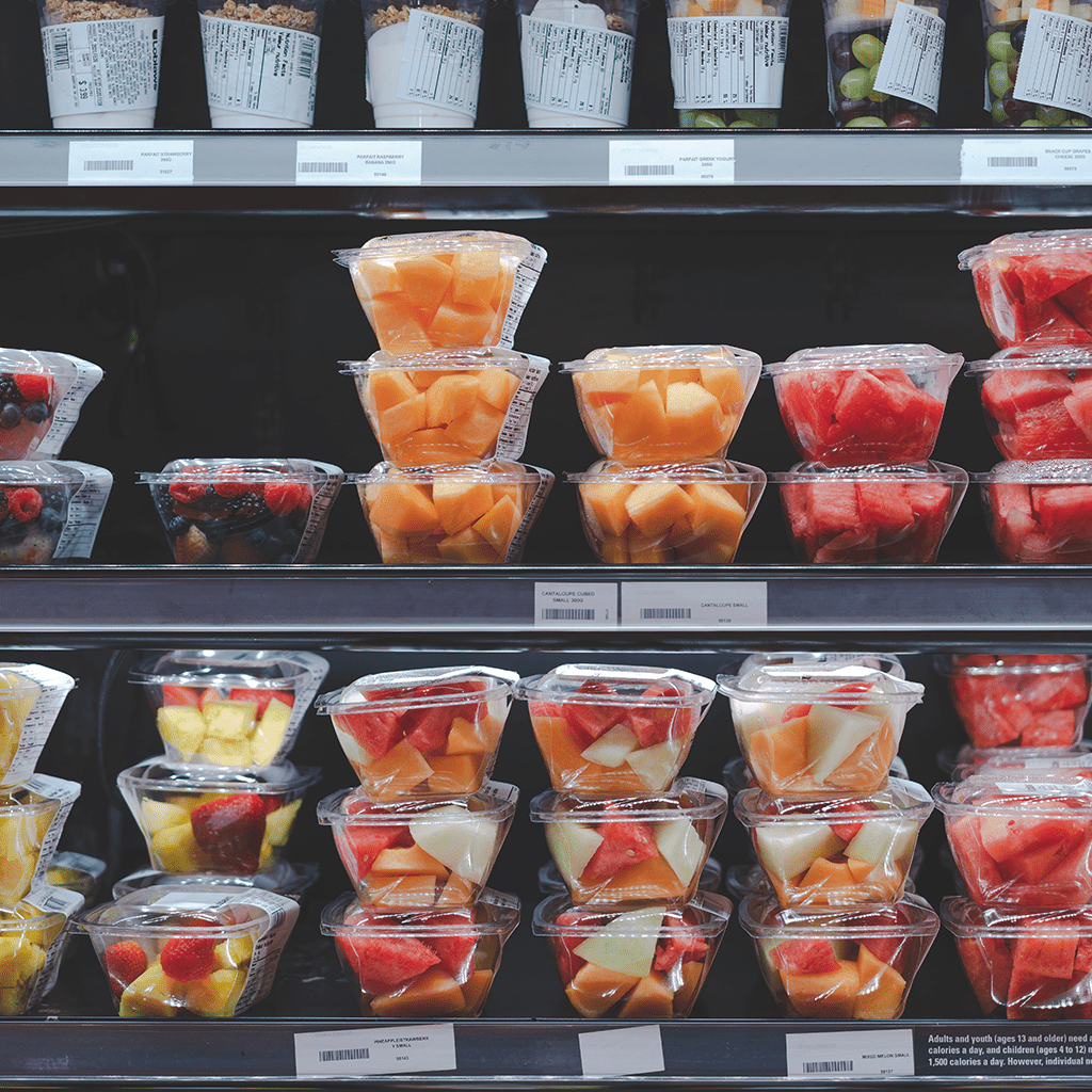 Boxes of fruit inside a fridge
